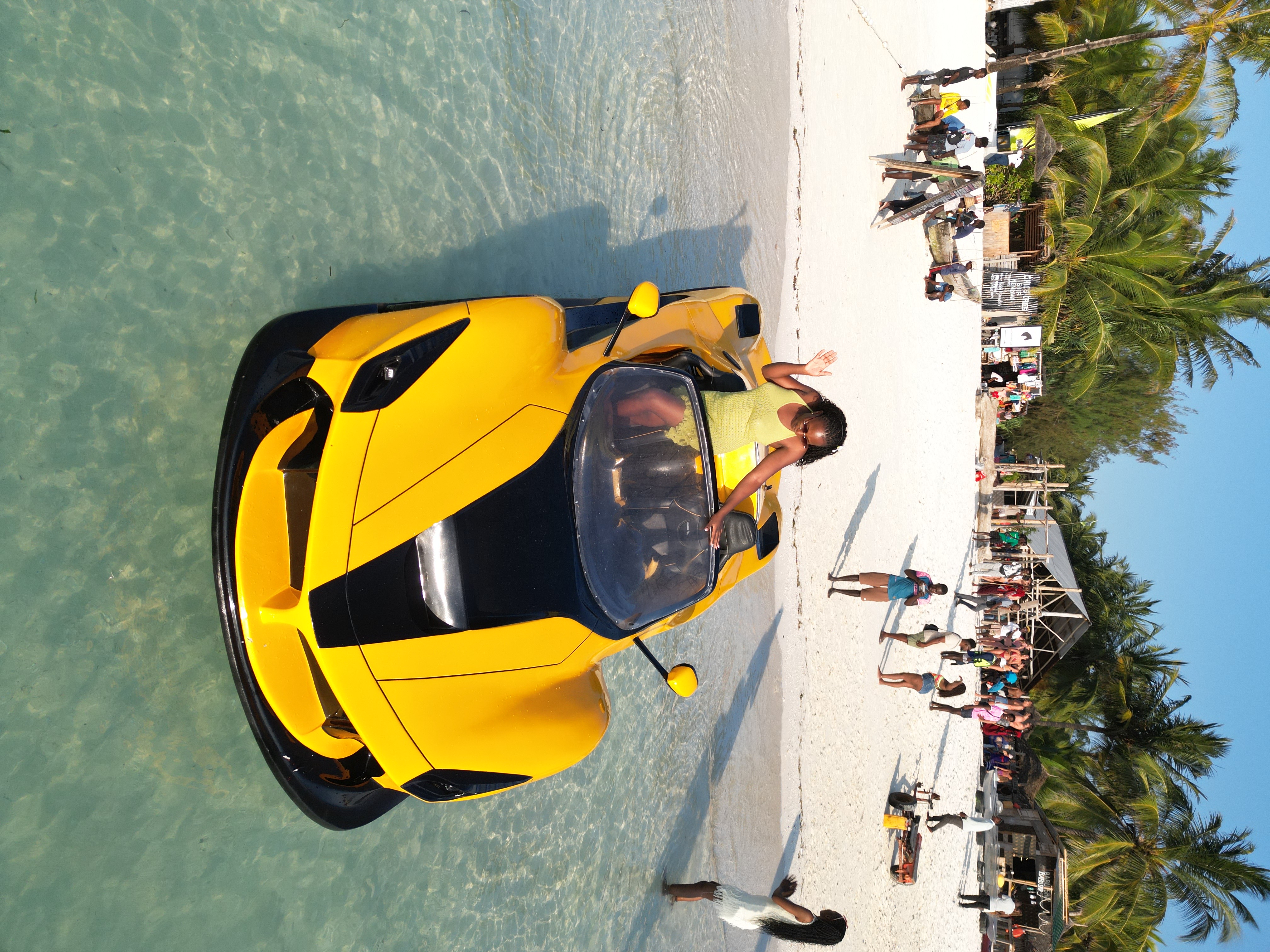 Visitors enjoying beach activities on white sand in Zanzibar